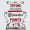 A typographic design on a light gray background reading 'TRYING TO EARN Brownie POINTS' with a red pencil and an open book illustration featuring red hearts.